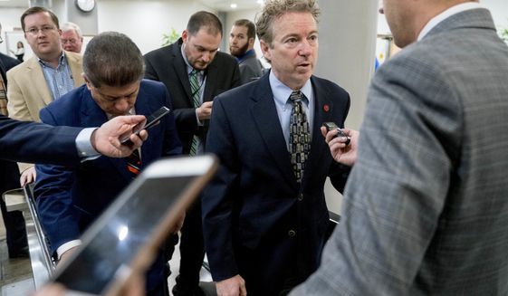 Sen. Rand Paul, R-Ky., speaks to reporters as he walks towards the Senate as Congress moves closer to the funding deadline to avoid a government shutdown on Capitol Hill in Washington, Thursday, Jan. 18, 2018. (AP Photo/Andrew Harnik)