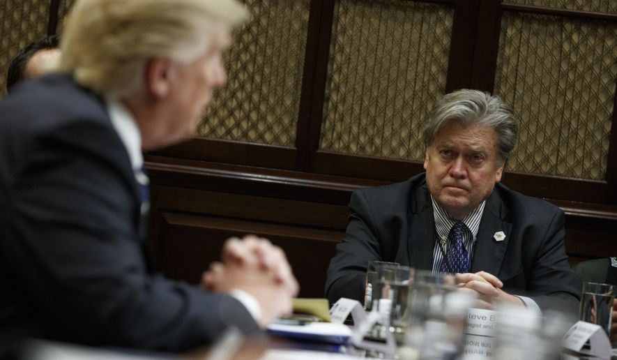 In this file photo, then-White House Chief Strategist Steve Bannon listens as President Donald Trump speaks during a meeting on cybersecurity in the Roosevelt Room of the White House on Jan. 31, 2017. (Associated Press) **FILE**