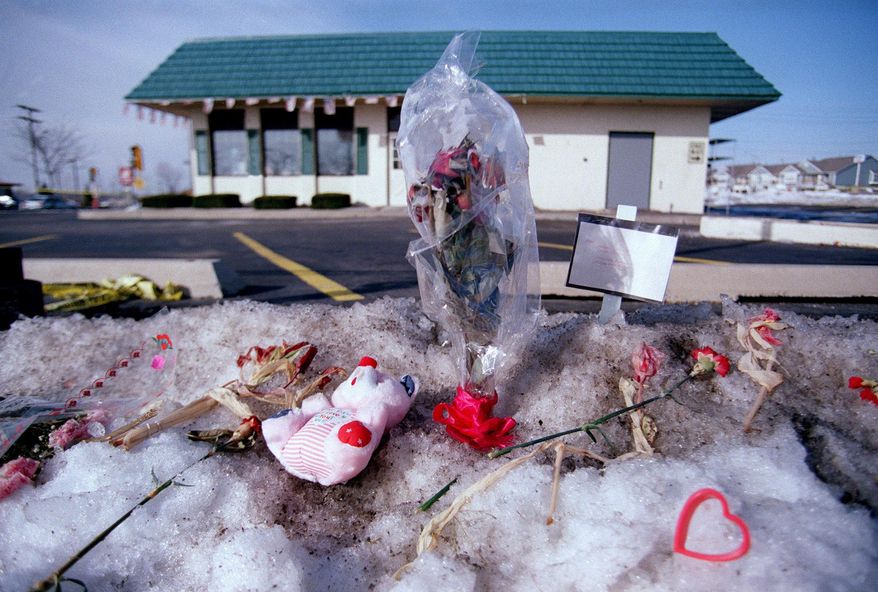 FILE - In this 1993 file photo memorials including flowers, signs, Valentine hearts and stuffed teddy bears are place outside the Brown's Chicken & Pasta in Palatine, Ill., after seven people were murdered there on January 8, 1993. For the past 25 years, owner Frank Portillo Jr.'s thoughts at this time of year have been with those seven people. (Dave Tonge/Daily Herald via AP File)