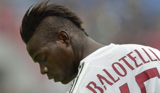 FILE - In this Sunday, March 6, 2016 file photo, AC Milan&#x27;s Mario Balotelli looks down during a Serie A soccer match against Sassuolo, at Reggio Emilia&#x27;s Mapei stadium, Italy. Mario Balotelli’s return to top form with Nice owes much to the astute guidance of coach Lucien Favre. He has matched his career-best 18 goals and is thriving on the responsibility of leading Nice’s attack. (AP Photo/Marco Vasini, file)
