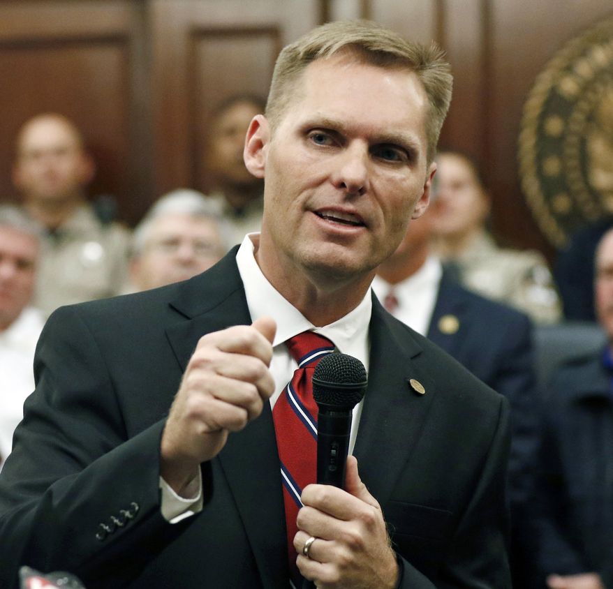 Michael Guest, district attorney for Madison and Rankin Counties, officially announces, Thursday, Jan. 18, 2018 at the Rankin County Courthouse in Brandon, Miss., that he is seeking the seat for Mississippi's 3rd Congressional District as a Republican. Guest has served as district attorney since 2008. U.S. Rep. Gregg Harper, R-Miss., has announced he is not seeking reelection. (AP Photo/Rogelio V. Solis)