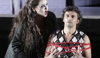 FILE - In this June 21, 2013, file photo, Jonas Kaufmann, right, in the role of Manrico and Elena Manistina as Azucena sing during a dress rehearsal for the opera &amp;quot;Il Trovatore&amp;quot; by Giuseppe Verdi in the Bavarian State Opera House in Munich, southern Germany. The world’s most sought-after tenor is back in the United States after a four-year absence caused mostly by illness but partly by a desire to spend more time with his children. (AP Photo/Matthias Schrader, File)