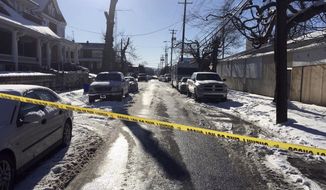 Crime tape stretches across a road near the scene of a shooting Thursday, Jan. 18, 2018, in Harrisburg, Pa. The mayor of Harrisburg said a U.S. marshal is dead after being shot while serving an arrest warrant in the city. Mayor Eric Papenfuse said two other officers were wounded in the Thursday morning shooting. (AP Photo/Marc Levy)