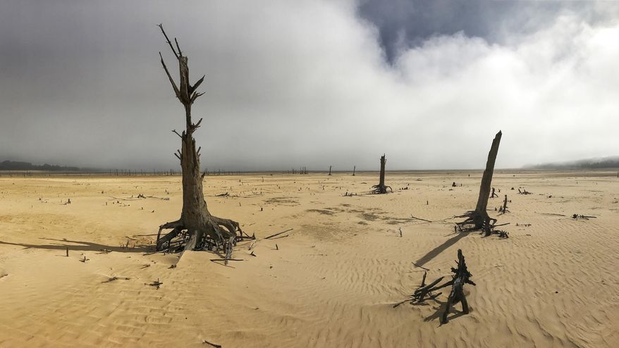 FILE - In this Sunday, April 16, 2017 file photo, the Theewaterskloof Dam, a key source of water supply to Cape Town, South Africa, is shown at low levels. The city announced new water restrictions Thursday, Jan 18, 2018 to combat the drought, saying it was looking more likely that it will have to turn off most taps on "Day Zero," or April 21. Mayor Patricia de Lille said 60 percent of residents are "callously" using more than the current limit and that the city will fine households that use too much water. (AP Photo/Halden Krog, File)