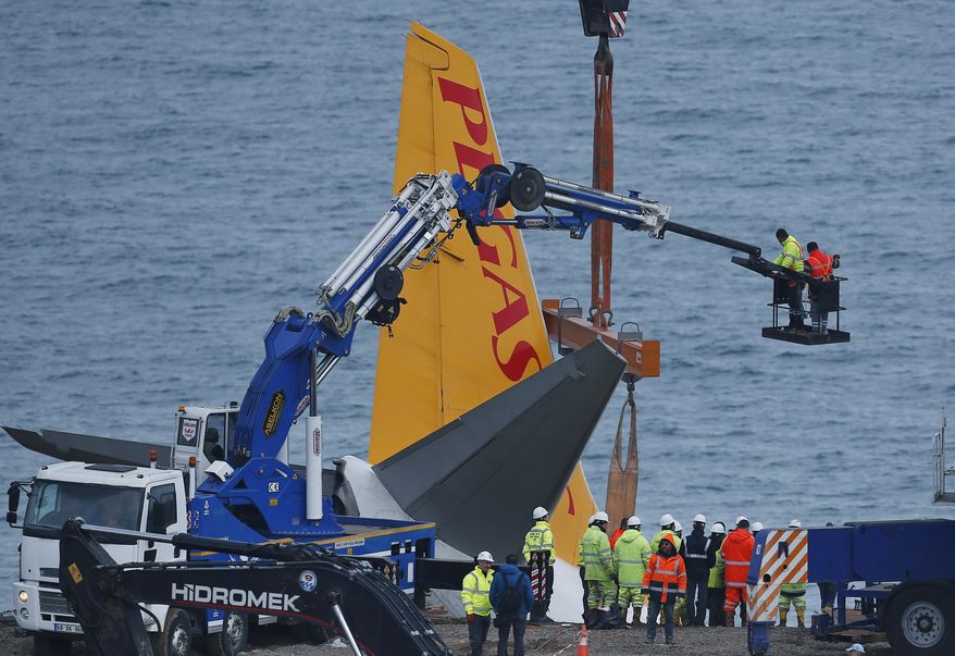 Workers on a recovery operation around a Boeing 737-800 of Turkey's Pegasus Airlines in Trabzon, Turkey, Thursday, Jan. 18, 2018. The Pegasus Airlines Boeing 737-800, with 168 people on board, went off the runway at Trabzon Airport late on Saturday, stopping at an acute angle only a few meters away from the Black Sea. All passengers and crew were evacuated and no one was injured. (AP Photo/Lefteris Pitarakis)