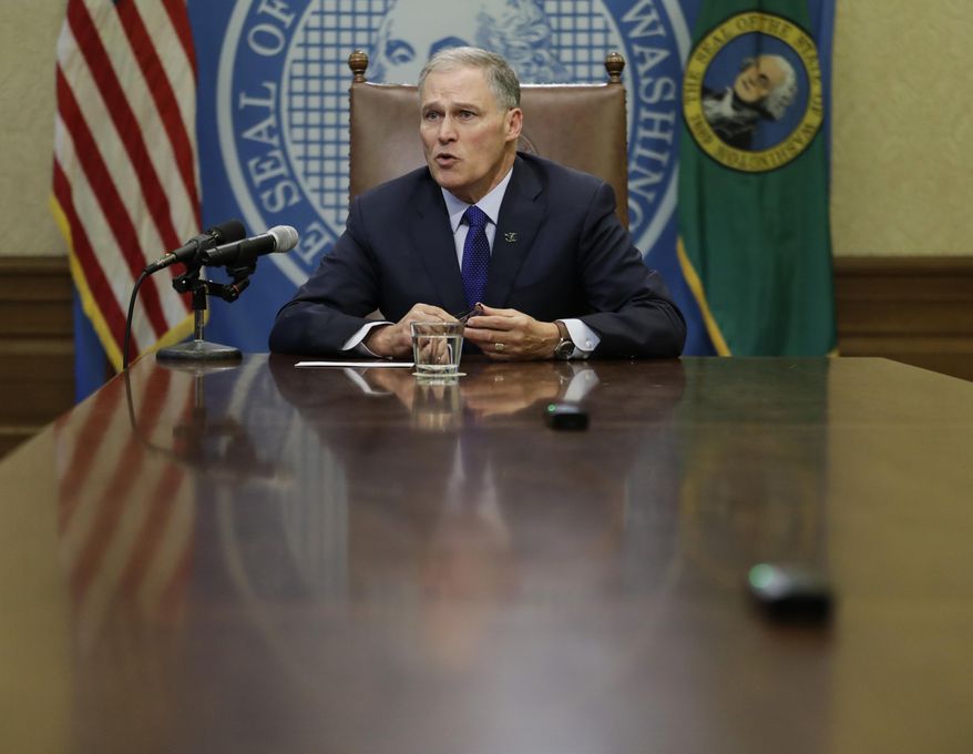 Washington Gov. Jay Inslee takes questions from reporters after he signed the capital budget, Friday, Jan. 19, 2018 at the Capitol in Olympia, Wash. The signing came after the state Legislature approved more than $4 billion in construction projects across the state after reaching a deal on a contentious water issue that had stalled the capital budget for months. (AP Photo/Ted S. Warren)