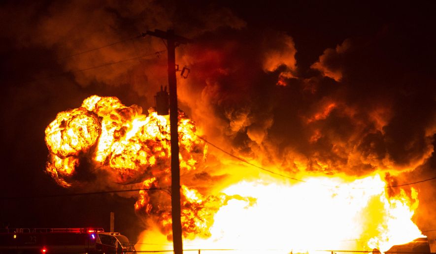 Firefighters attempt to put out a burning trailer that was hauling thousands of gallons of fuel on Interstate 15 in Midvale, Utah, Thursday, Jan. 18, 2018. Lt. Todd Royce of the Utah Highway Patrol said the truck was southbound on the interstate when a tire caught fire, sending flames toward the tanks. (Chris Detrick/The Salt Lake Tribune via AP)