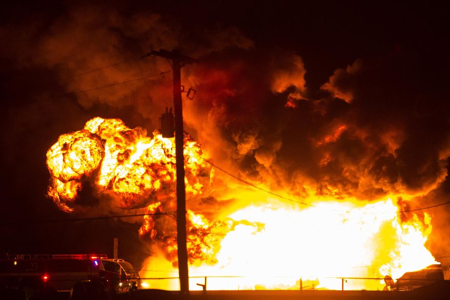 Firefighters attempt to put out a burning trailer that was hauling thousands of gallons of fuel on Interstate 15 in Midvale, Utah, Thursday, Jan. 18, 2018. Lt. Todd Royce of the Utah Highway Patrol said the truck was southbound on the interstate when a tire caught fire, sending flames toward the tanks. (Chris Detrick/The Salt Lake Tribune via AP)