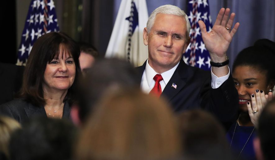 Vice President Mike Pence with his wife Karen Pence, left, waves to anti-abortion supporters and participants of the annual March for Life event, during a reception in the Indian Treaty Room at the Eisenhower Executive Office Building on the White House complex in Washington, Thursday, Jan. 18, 2018. (AP Photo/Manuel Balce Ceneta)