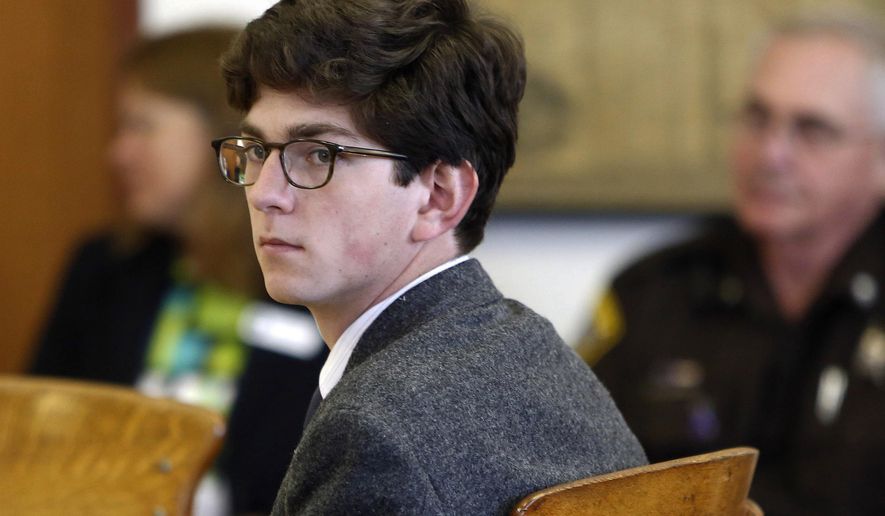FILE - In this Tuesday Aug. 18, 2015 file photo, St. Paul's School student Owen Labrie looks around the courtroom at the start of his trial. Labrie was convicted of sexually assaulting a 15-year-old freshman girl as part of a game of sexual conquest. The prep school announced Friday, Jan. 19, 2018, it had settled a lawsuit filed by the parents of the student who accused Labrie of was sexually assaulting their daughter in 2014. (AP Photo/Jim Cole, File)