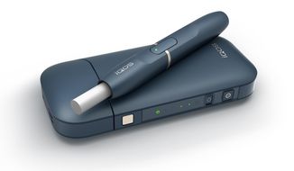 This undated image provided by Philip Morris in January 2018 shows the company&#x27;s iQOS product. The device heats tobacco sticks but stops short of burning them, an approach that Philip Morris says reduces exposure to tar and other toxic byproducts of burning cigarettes. This is different from e-cigarettes, which don’t use tobacco at all but instead vaporize liquid usually containing nicotine. (Philip Morris via AP)