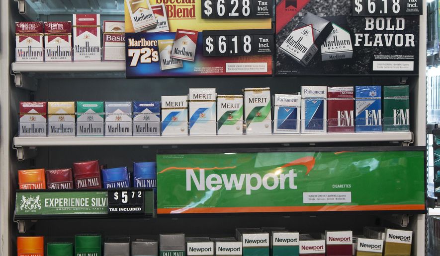 In this Thursday, May 18, 2017 file photo, packs of cigarettes are offered for sale at a convenience store in Helena, Mont. Tobacco companies have made claims about “safer” cigarettes since the 1950s, all later proven false. In some cases the introduction of these products, such as filtered and “low tar” cigarettes, propped up cigarette sales and kept millions of Americans smoking. Although the adult smoking rate has fallen to an all-time low of 15 percent in 2017, smoking remains the nation&#39;s leading preventable cause of death and illness, responsible for about one in five U.S. deaths. (AP Photo/Bobby Caina Calvan)