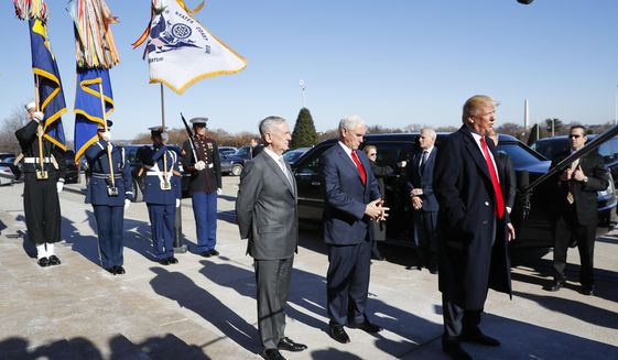 President Donald Trump, joined by Defense Secretary Jim Mattis, left, and Vice President Mike Pence, speaks to the media as he arrives at the Pentagon, Thursday, Jan. 18, 2018. (AP Photo/Pablo Martinez Monsivais)