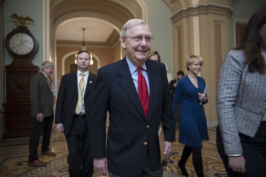 Senate Majority Leader Mitch McConnell, R-Ky., walks to the chamber on the first morning of a government shutdown after a divided Senate rejected a funding measure last night, at the Capitol in Washington, Saturday, Jan. 20, 2018. (AP Photo/J. Scott Applewhite)