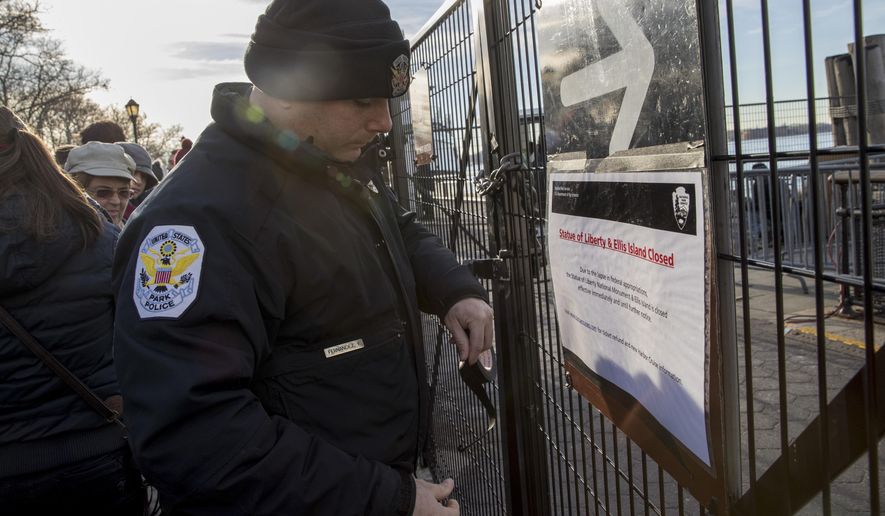 A United States Park Police officer post a sign informing of the Statue of Liberty and Ellis Island closing at an entrance to the ferry, Saturday, Jan. 20, 2018, in New York. The National Park Service announced that the Statue of Liberty and Ellis Island would be closed Saturday &amp;quot;due to a lapse in appropriations.&amp;quot; Late Friday, the Senate failed to approve legislation to keep the government from shutting down after the midnight deadline. (AP Photo/Mary Altaffer)