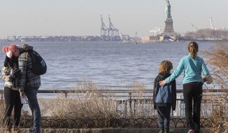 Visitors to the Statue of Liberty take in the sight from battery park, Saturday, Jan. 20, 2018, in New York. The National Park Service announced that the Statue of Liberty and Ellis Island would be closed Saturday &amp;quot;due to a lapse in appropriations.&amp;quot; Late Friday, the Senate failed to approve legislation to keep the government from shutting down after the midnight deadline. (AP Photo/Mary Altaffer)