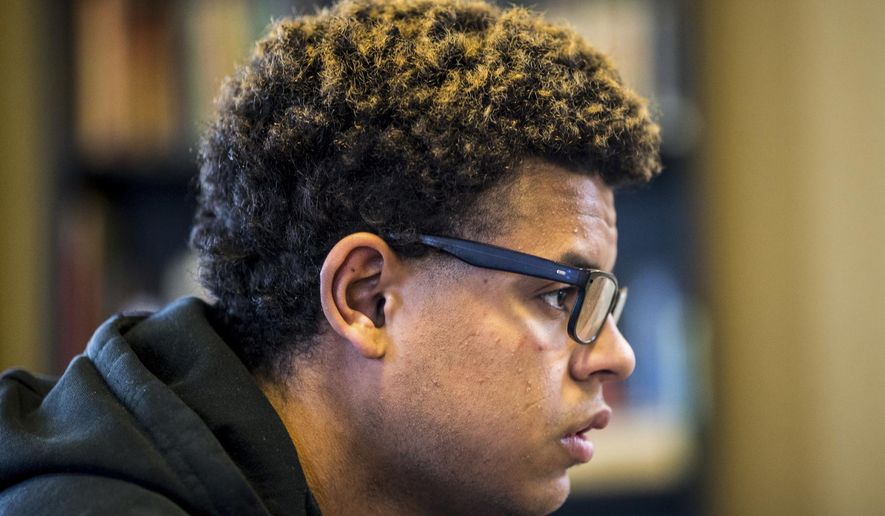 In this Jan. 5, 2018 photo, Cory Butler, 20, sits in the living room of Rod's House in Yakima, Wash. Butler has been homeless since he was 18, but has plans of getting his GED and becoming a tattoo artist. (Jake Parrish/Yakima Herald-Republic via AP)