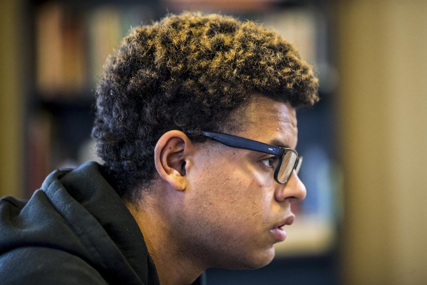 In this Jan. 5, 2018 photo, Cory Butler, 20, sits in the living room of Rod's House in Yakima, Wash. Butler has been homeless since he was 18, but has plans of getting his GED and becoming a tattoo artist. (Jake Parrish/Yakima Herald-Republic via AP)