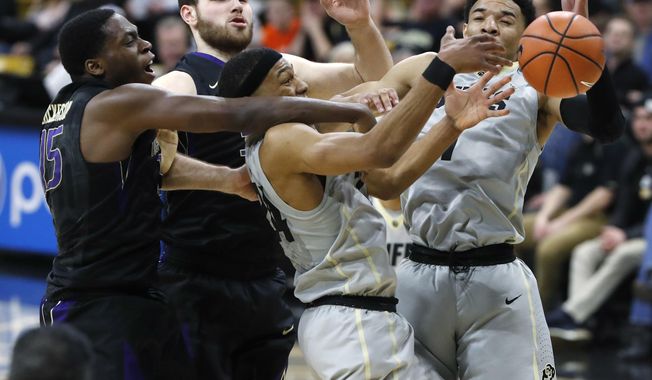 Washington forwards Noah Dickerson and Sam Timmins vie for control of a rebound with Colorado guards George King and Tyler Bey, from left, during the first half of an NCAA college basketball game Saturday, Jan. 20, 2018. (AP Photo/David Zalubowski)