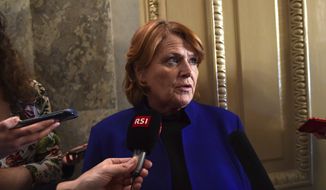 Sen. Heidi Heitkamp, D-N.D., talks with reporters on Capitol Hill in Washington, Monday, Jan. 22, 2018, after passage of a procedural vote aimed at reopening the government. (AP Photo/Susan Walsh) ** FILE **