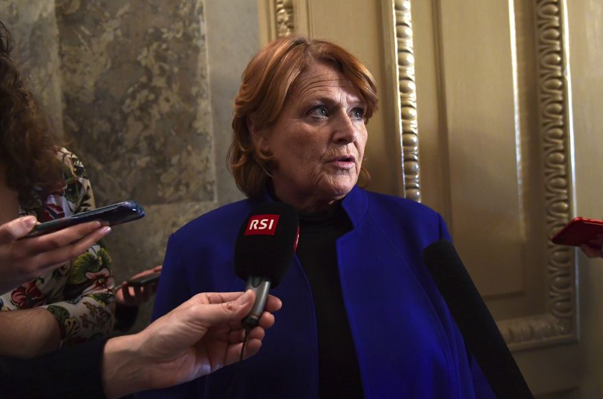 Sen. Heidi Heitkamp, D-N.D., talks with reporters on Capitol Hill in Washington, Monday, Jan. 22, 2018, after passage of a procedural vote aimed at reopening the government. (AP Photo/Susan Walsh) ** FILE **