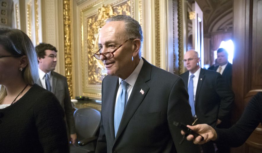 Senate Minority Leader Chuck Schumer, D-N.Y., heads to the chamber with fellow Democrats for a procedural vote aimed at reopening the government, at the Capitol in Washington, Monday, Jan. 22, 2018. (AP Photo/J. Scott Applewhite)