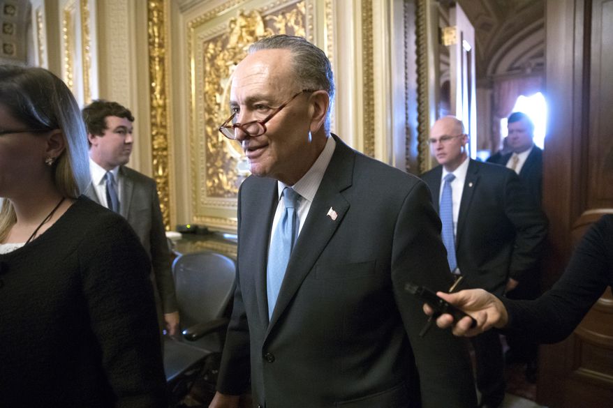 Senate Minority Leader Chuck Schumer, D-N.Y., heads to the chamber with fellow Democrats for a procedural vote aimed at reopening the government, at the Capitol in Washington, Monday, Jan. 22, 2018. (AP Photo/J. Scott Applewhite)