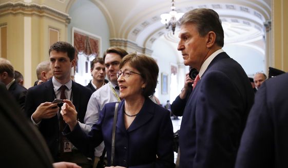 Sen. Susan Collins, R-Maine, left, and Sen. Joe Manchin, D-W.Va., speak to members of the media after leaving the Senate chamber which voted yes on a procedural vote to reopen the government, Monday Jan. 22, 2018,, on Capitol Hill in Washington. (AP Photo/Jacquelyn Martin)