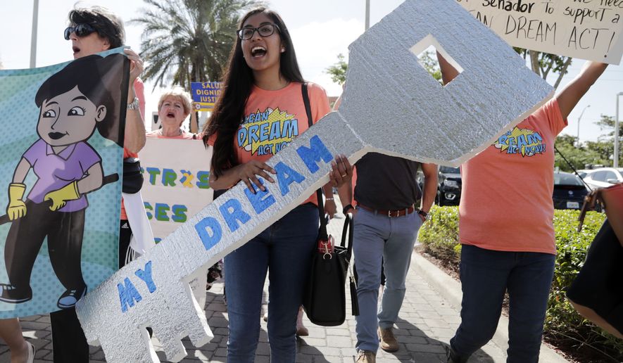 Maria Angelica Ramirez carries a large key reading &quot;My Dream&quot; during a protest outside the office of Sen. Marco Rubio, Florida Republican, in support of Deferred Action for Childhood Arrivals. (Associated Press)
