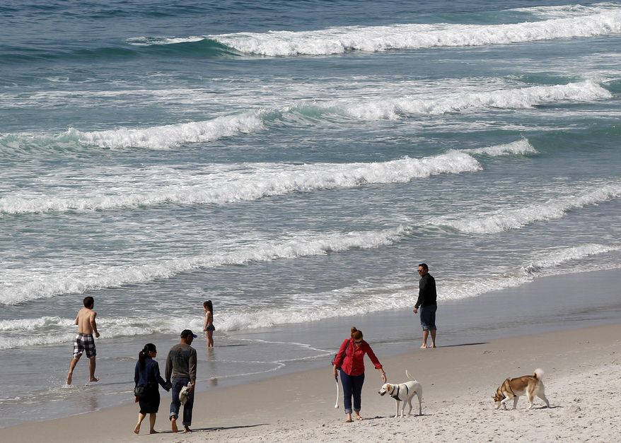 File - In this March 19, 2014 file photo, visitors converge on the beach in Carmel, Calif. Several beaches along California's Central Coast are closed after nearly five million gallons of sewage spilled into the ocean in Monterey County. The county's Environmental Health Department says the massive spill was stopped Saturday, Jan. 21, 2018, at the Monterey One Water wastewater treatment facility. At least eight beaches are closed in the area about 110 miles south of San Francisco. (AP Photo/Marcio Jose Sanchez, File)