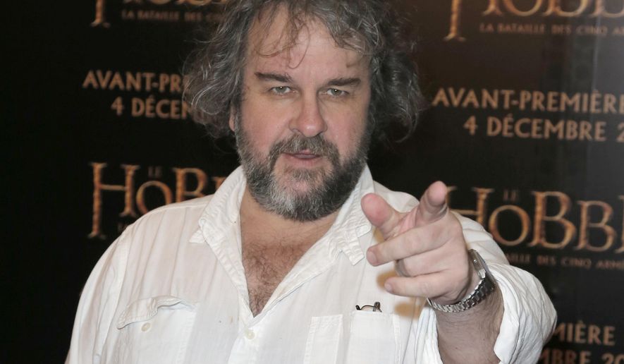 FILE - In this file photo dated Thursday, Dec. 4, 2014, director Peter Jackson poses for photos at the screening of his film The Hobbit. It is announced Monday Jan. 22, 2018, that Jackson is transforming grainy black-and-white archive film from the London Imperial War Museum using cutting-edge digital technology and hand coloring to transform World War I film into 3-D color, to mark the centenary of the 1914-18 conflict. (AP Photo/Francois Mori, FILE)