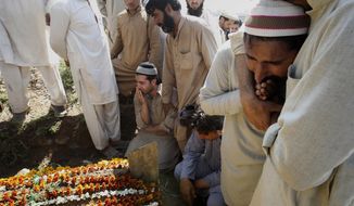 FILE - In this March 18, 2015 file photo, Pakistani villagers and family members mourn during the funeral of Pakistani lawyer Samiullah Khan Afridi, who was killed months after he announced that he will no longer be representing Dr. Shakil Afridi, in Peshawar, Pakistan. Shakil Afridi, who reportedly used a vaccination scam to identify Osama bin Laden’s home, has been languishing in jail since the al-Qaida leader was killed by U.S. Navy Seals in 2011 -- his case a metaphor for downward spiraling relations between his country and the U.S. (AP Photo/Mohammad Sajjad, File)