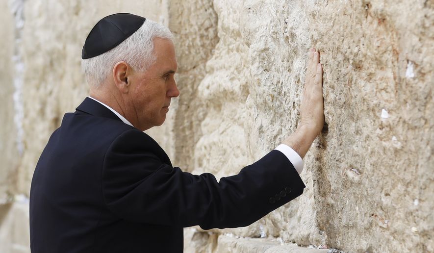 U.S. Vice President Mike Pence touches the Western Wall, Judaism&#39;s holiest prayer site, in Jerusalem&#39;s Old City, Tuesday, Jan. 23, 2018. (Ronen Zvulun/Pool photo via AP)