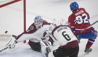 Montreal Canadiens center Jonathan Drouin (92) scores against Colorado Avalanche goaltender Jonathan Bernier (45) as defenseman Erik Johnson (6) defends during the third period of an NHL hockey game Tuesday, Jan. 23, 2018, in Montreal. (Graham Hughes/The Canadian Press via AP)
