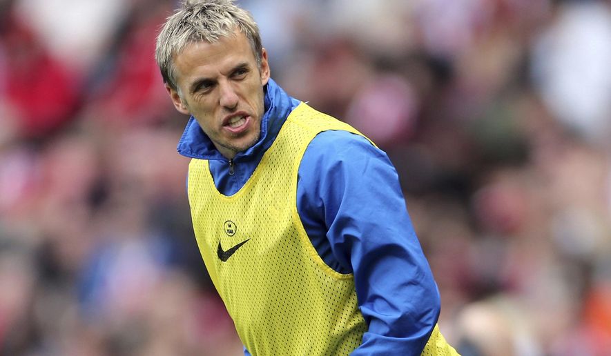FILE - A Saturday, April 20, 2013 file photo showing Everton&#39;s Phil Neville, during their English Premier League soccer match against Sunderland at the Stadium of Light, Sunderland, England. Phil Neville has been hired as manager of England’s women’s team. Since retiring from playing in 2013, Neville has had brief spells as an assistant coach with the England Under-21 men’s team, United and Valencia. He has also managed Salford City _ the semi-professional team he co-owns with other former United players _ for one game. (AP Photo/Scott Heppell, File)