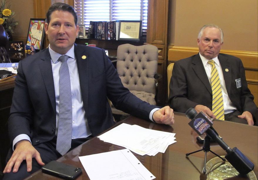 In this Monday, Jan. 22, 2018, photo, Kansas House Speaker Ron Ryckman Jr., left, R-Olathe, and Majority Leader Don Hineman, R-Dighton, discuss transparency measures during a news conference at the Statehouse in Topeka, Kan. House GOP leaders are taking steps to ensure that the public has more information about which legislators and groups are behind legislation (AP Photo/John Hanna)
