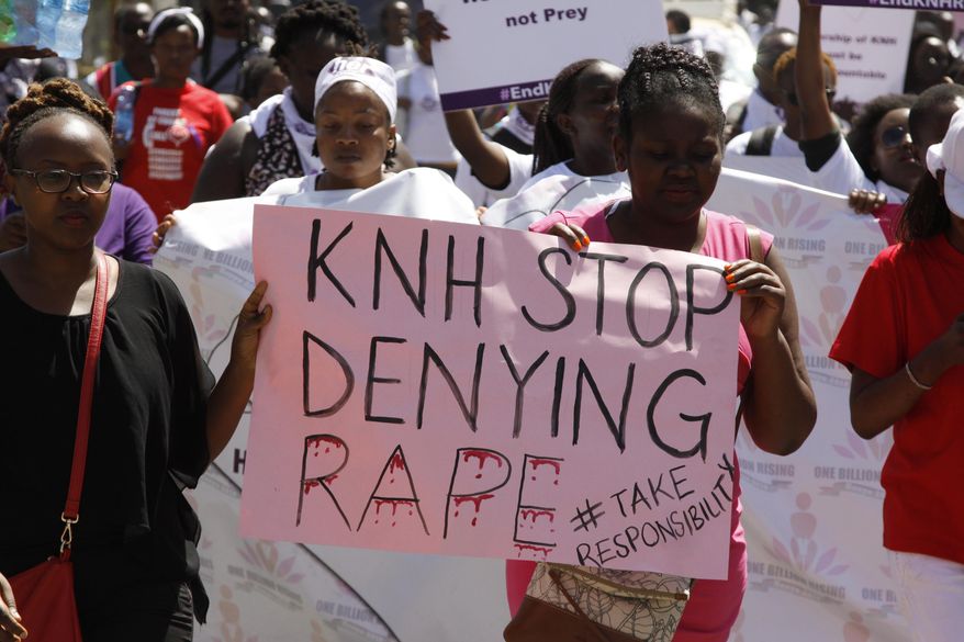 Protesters march along the streets of Nairobi holding placards against the rape allegation by staff of Kenyatta national hospital in Nairobi, Kenya Tuesday, Jan. 23, 2018. Protesters allege it is difficult for victims of sexual assault to go to police, and want swift investigations while demanding changes to make women safe at hospital. (AP Photo/Khalil Senosi)