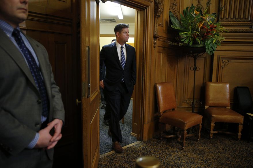 Supervisor Mark Farrell walks back into the meeting at City Hall after being voted interim mayor by the board of supervisors, Tuesday, Jan. 23, 2018, in San Francisco. (Santiago Mejia/San Francisco Chronicle via AP)