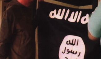 FILE - In this July 8, 2017 file image taken from FBI video and provided by the U.S. Attorney&#x27;s Office in Hawaii on July 13, 2017, Army Sgt. 1st Class Ikaika Kang holds an Islamic State group flag after allegedly pledging allegiance to the terror group at a house in Honolulu. Newly unsealed court documents from an investigation into the Hawaii-based Army soldier accused of attempting to support the Islamic State group, provides more details about his obsession with the group&#x27;s violence. (FBI/U.S Attorney&#x27;s Office, District of Hawaii via AP, File)