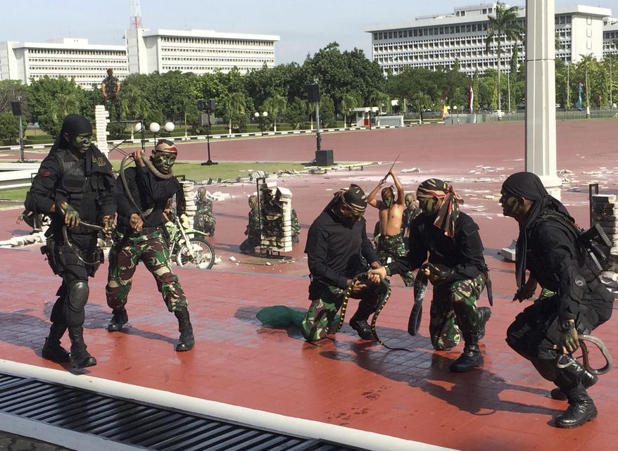 Indonesian special forces demonstrate snake-handling Wednesday, Jan. 24, 2018, for U.S. Defense Secretary Jim Mattis in Jakarta, Indonesia. (AP Photo/Robert Burns)