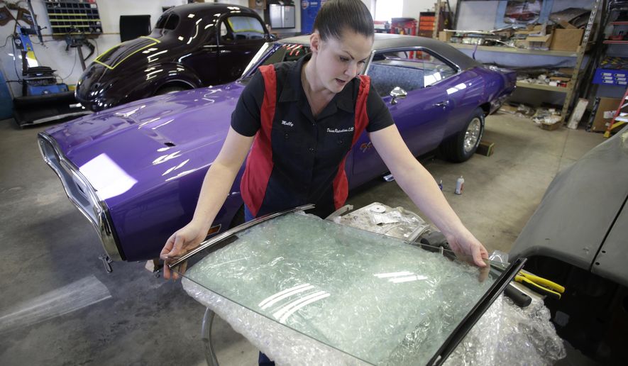 ADVANCE FOR USE MONDAY, JAN. 29 - In this Thursday, Jan. 18, 2018 photo, shop owner Molly Gursky works on the window off a 1967 Pontiac Firebird at Driven Restorations LLC, a classic car restoration shop, in Randolph, Wis. The shop is expanding after seven years in their current location. (Steve Apps/Wisconsin State Journal via AP)