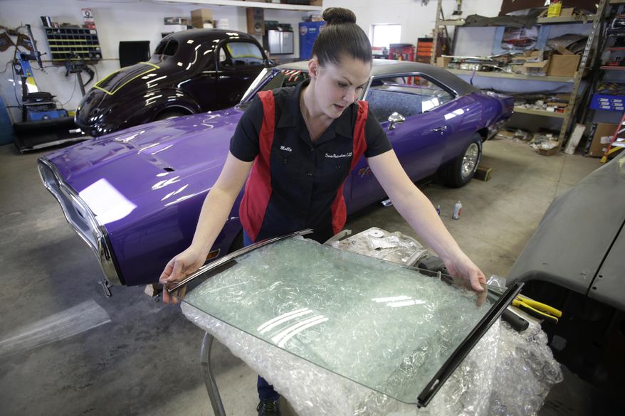 ADVANCE FOR USE MONDAY, JAN. 29 - In this Thursday, Jan. 18, 2018 photo, shop owner Molly Gursky works on the window off a 1967 Pontiac Firebird at Driven Restorations LLC, a classic car restoration shop, in Randolph, Wis. The shop is expanding after seven years in their current location. (Steve Apps/Wisconsin State Journal via AP)