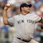 FILE - In this July 23, 2007, file photo, New York Yankees starting pitcher Roger Clemens throws to a Kansas City Royals batter during the first inning of a baseball game in Kansas City, Mo. Clemens and Barry Bonds fell short in elections to the baseball Hall of Fame. (AP Photo/Ed Zurga, File)