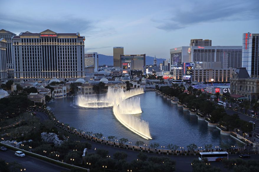 File - In this April 4, 2017, file photo, the fountains of Bellagio erupt along the Las Vegas Strip in Las Vegas. The union representing hotel workers in Las Vegas will ask casino-resort operators to give every housekeeper a 'panic button' as part of their new contracts. Leaders of the Culinary Union will bring the request to the bargaining table next month on behalf of 14,000 housekeepers who work on the Las Vegas Strip and the destination's downtown area. The push comes amid the #MeToo movement against sexual assault and harassment and is in line with ordinances recently approved in other cities. (AP Photo/John Locher, File)