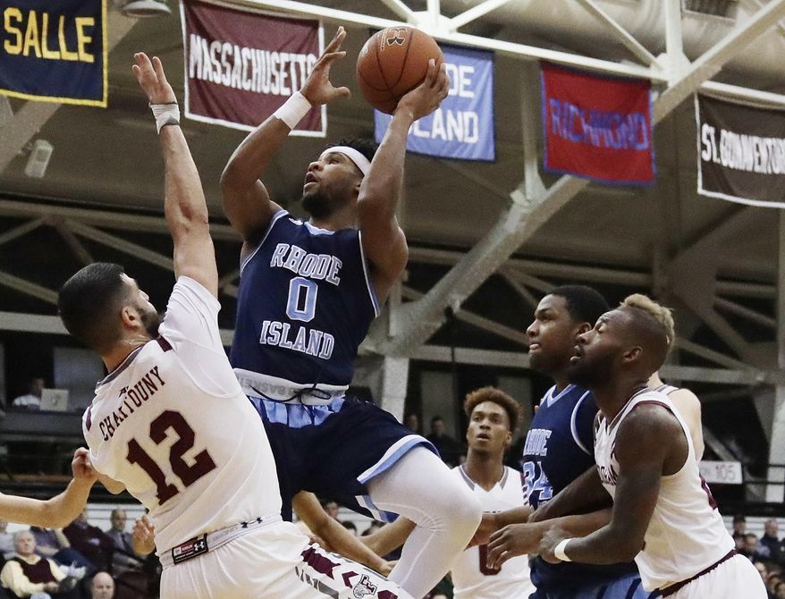 Rhode Island's E.C. Matthews (0) shoots over Fordham's Joseph Chartouny (12) during the first half of an NCAA college basketball game Wednesday, Jan. 24, 2018, in New York. (AP Photo/Frank Franklin II)