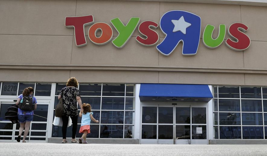 FILE - In this Sept. 19, 2017, file photo, shoppers walk into a Toys R Us store, in San Antonio. Toys R Us says it will be closing some U.S. stores and converting others to cobranded locations as it continues to deal with its financial restructuring following its bankruptcy filing. (AP Photo/Eric Gay, File)