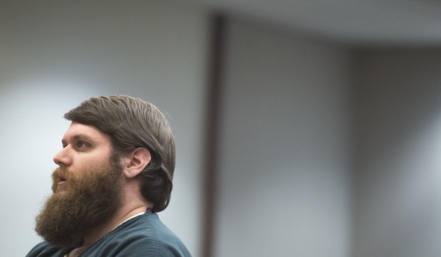 James Chelekis speaks to Judge Paul Sullivan at the Kent County Courthouse in downtown Grand Rapids, Mich., on Tuesday, Jan. 23, 2018. Chelekis, a former teacher has been sentenced to 30 to 60 years in prison for slashing his wife’s throat after she discovered he was having an affair with someone who turned out to be a middle-school student. (Casey Sykes/The Grand Rapids Press via AP)