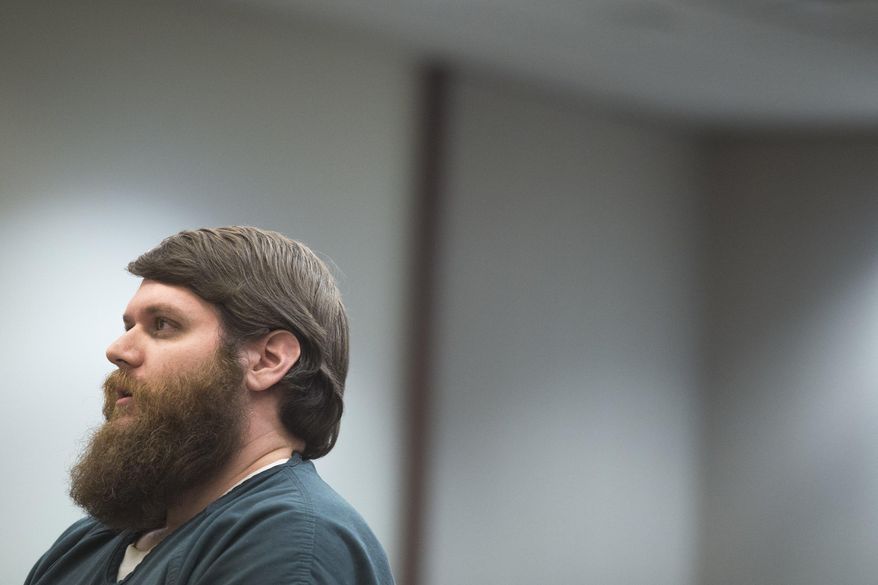 James Chelekis speaks to Judge Paul Sullivan at the Kent County Courthouse in downtown Grand Rapids, Mich., on Tuesday, Jan. 23, 2018. Chelekis, a former teacher has been sentenced to 30 to 60 years in prison for slashing his wife’s throat after she discovered he was having an affair with someone who turned out to be a middle-school student. (Casey Sykes/The Grand Rapids Press via AP)