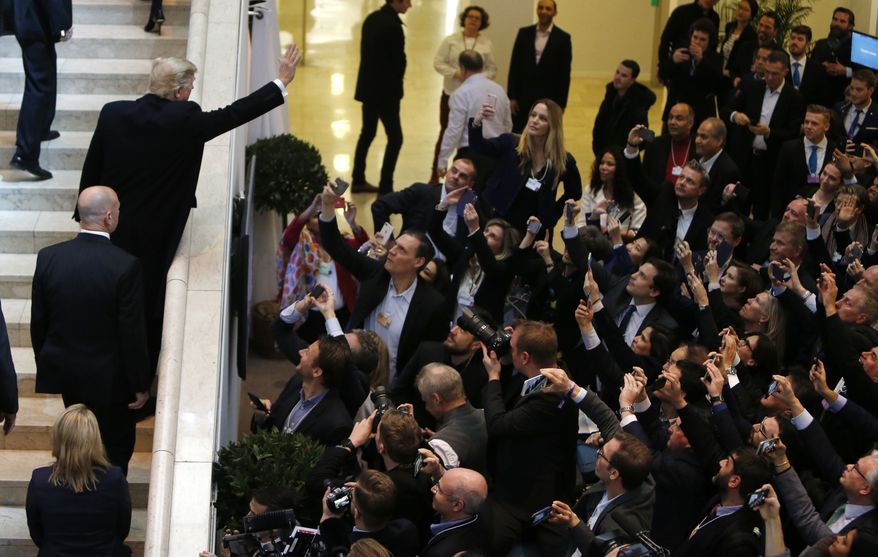U.S. President Donald Trump waves as he arrives during the annual meeting of the World Economic Forum in Davos, Switzerland, Thursday, Jan. 25, 2018. (AP Photo/Michael Probst)
