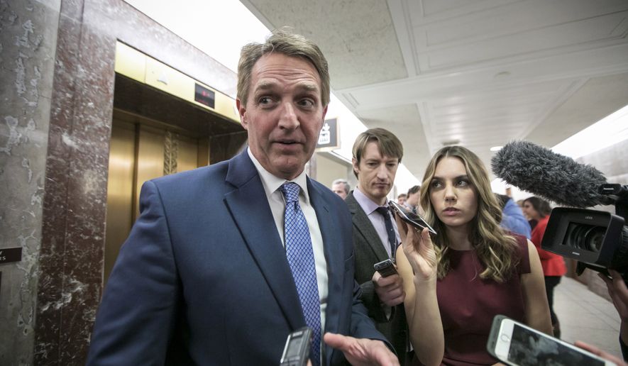 Sen. Jeff Flake, R-Ariz., speaks to reporters as he leaves the office of Sen. Susan Collins, R-Maine, who is moderating bipartisan negotiations on immigration, at the Capitol in Washington, Thursday, Jan. 25, 2018. President Donald Trump has given Congress until March to come up with a plan to protect the nearly 700,000 young people who had been protected from deportation and given the right to work legally in the country under the Obama-era Deferred Action for Childhood Arrivals program, or DACA. Trump announced he was ending DACA last year. (AP Photo/J. Scott Applewhite)